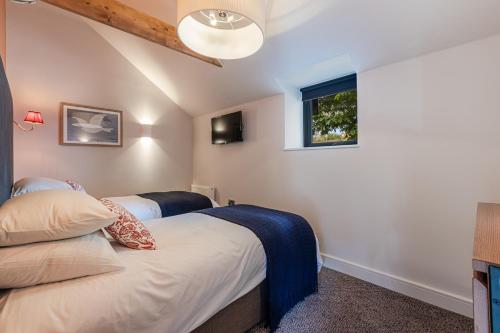 a bedroom with two beds and a window at Waterside Apartment in Paignton