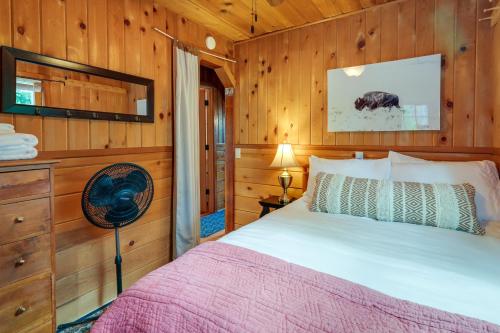 a bedroom with a bed and a fan at Twain Harte Cabin with Deck and Fire Pit! in Twain Harte