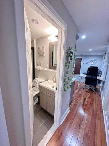 a bathroom with a sink and a mirror and a chair at Renovated Private 1B/1B w Kitchen in Philadelphia