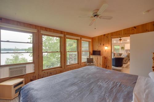 a bedroom with a large bed and windows at Lakefront Osceola Vacation Rental - Dogs Welcome! in Osceola