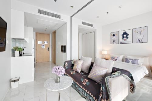 a living room with a couch and a bed at The Echelon Sukhumvit 11 by LeFoyer in Bangkok