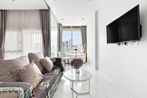 a living room with a couch and a table at The Echelon Sukhumvit 11 by LeFoyer in Bangkok