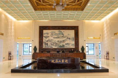 a lobby with a couch in the middle of a building at Chengde Imperial Palace Hotel in Chengde