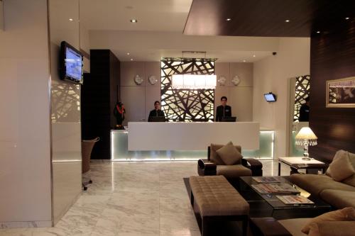 a lobby with two people standing at a counter at Krishna Palace Hotel in Mumbai