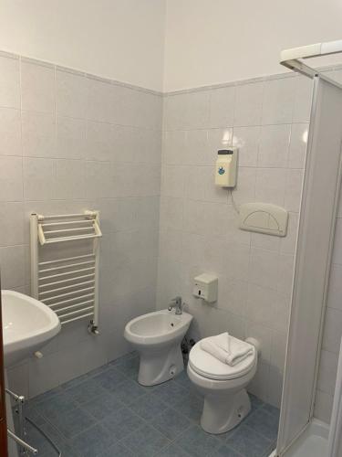 a white bathroom with a toilet and a sink at Sportland in Colle Val D'Elsa