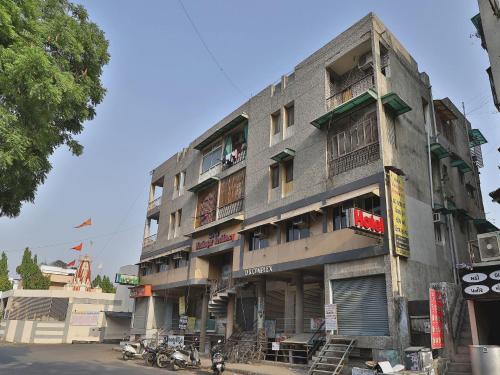 a tall building with motorcycles parked in front of it at Hotel Maninagar Residency in Ahmedabad