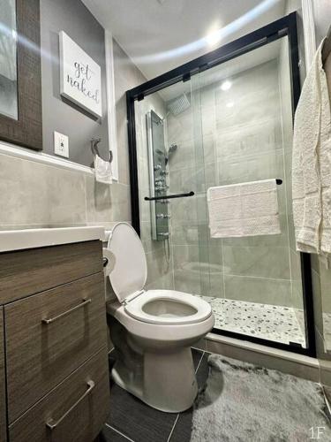 a bathroom with a toilet and a glass shower at Renovated Private 1B/1B w/ Kitchen in Philadelphia