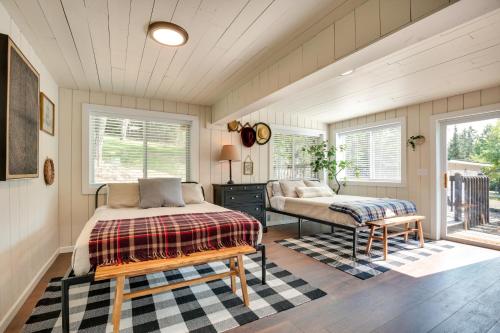 a bedroom with a bed and a bench and windows at Eagle River Retreat Near Dam Lake with Boat Dock! in Eagle River
