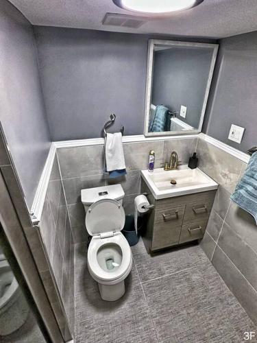 a small bathroom with a toilet and a sink at Renovated Private 1B/1B W/ Kitchen in Philadelphia