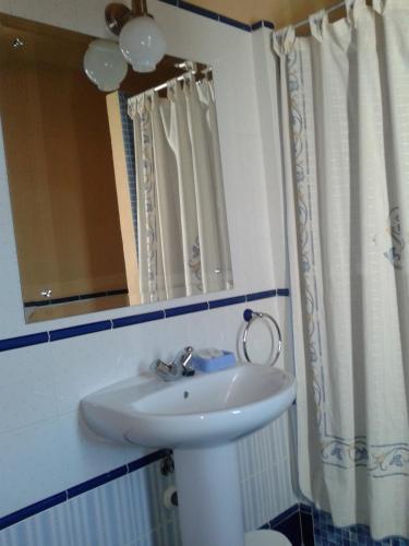 a bathroom with a white sink and a mirror at Casa Rural La Vallejera in Tejeda de Tiétar