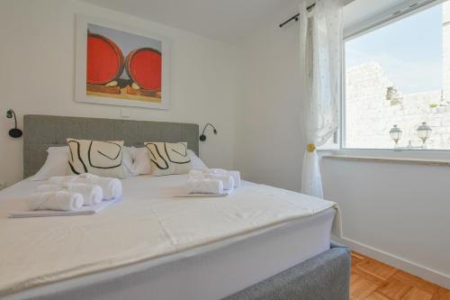 a bedroom with a bed with two towels on it at Apartment Sidro in Pag
