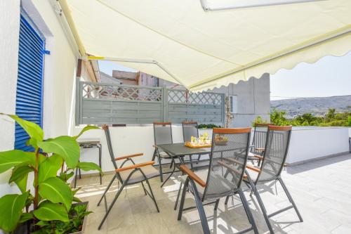 a patio with a table and chairs on a balcony at Apartment Sidro in Pag