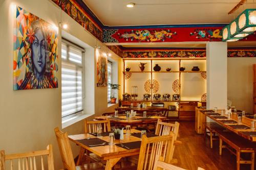 a dining room with wooden tables and chairs at Hotel Lingzi in Leh