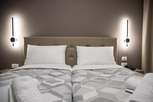 a bedroom with a large bed with two pillows at Comfort Rooms Pogradec in Pogradec