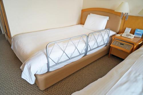 Katil atau katil-katil dalam bilik di Royal Pines Hotel Urawa