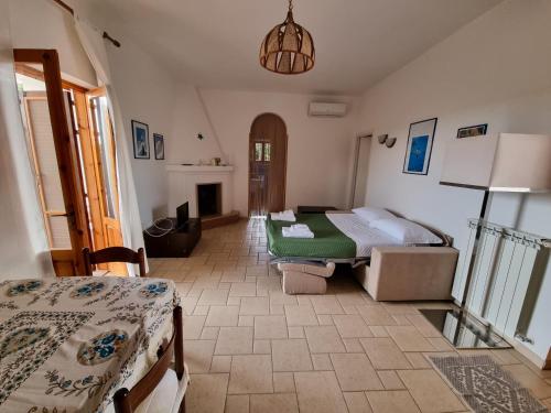 a bedroom with two beds and a fireplace at Villa Temistocle in Torre Santa Sabina