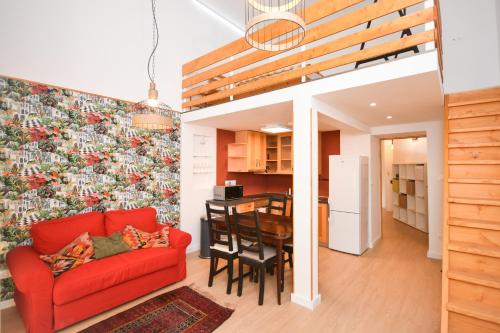 a living room with a red couch and a table at Comfortable Apartament on the Boulevard for 4 people in Budapest