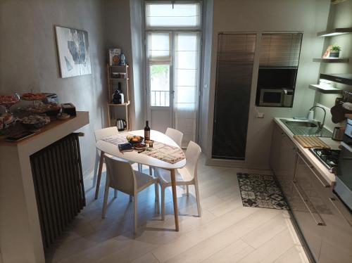 a kitchen with a table and chairs in a kitchen at La contrada in Cuneo