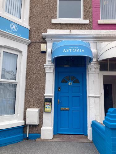 a blue door on the side of a building at The New Astoria Hotel in Blackpool