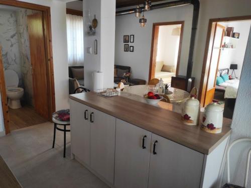 a kitchen with a counter with a sink and a mirror at Τα πλατάνια 