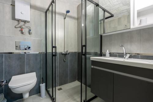 a bathroom with a shower and a toilet and a sink at ANTSUN in Antalya