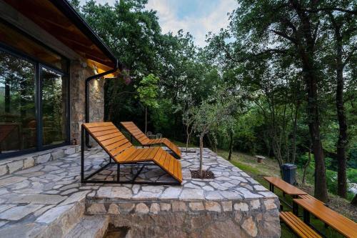 a couple of benches sitting on a stone patio at Rijeka Zeta, Podgorica in Podgorica