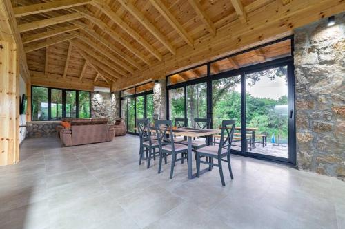 a dining room with a table and chairs and a couch at Rijeka Zeta, Podgorica in Podgorica