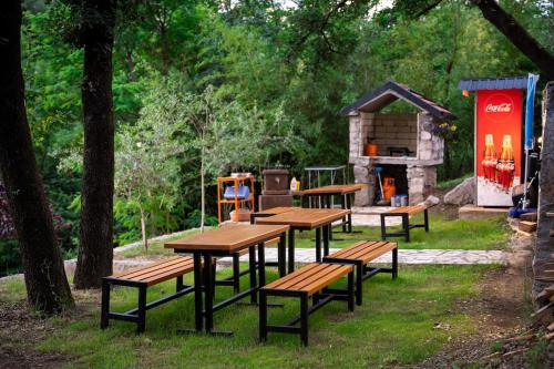 a group of picnic tables and benches in a park at Rijeka Zeta, Podgorica in Podgorica