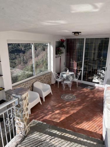 a living room with a table and chairs at Casa Vacanza Paola Aurigo in Aurigo