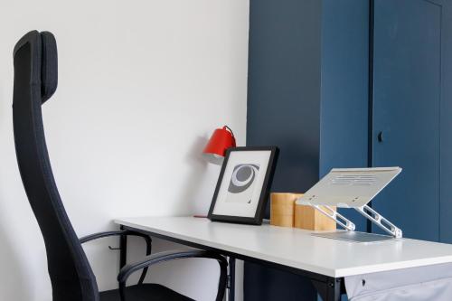 a desk with a laptop computer on top of it at Suburban Hideaway in Suffolk in Ipswich