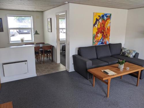 a living room with a couch and a table at Sevel Kro in Vinderup