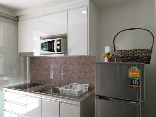 a kitchen with a sink and a microwave at 2 Floor - Centrio Condominium near Central Shopping Mall and Phuket Old town in Phuket