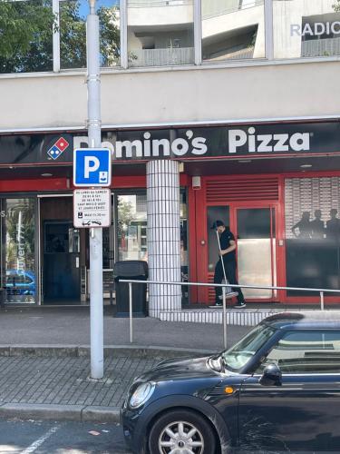 a car parked on a street in front of a store at Appartement 3 pièces pour 1 à 5 voyageurs in Rillieux