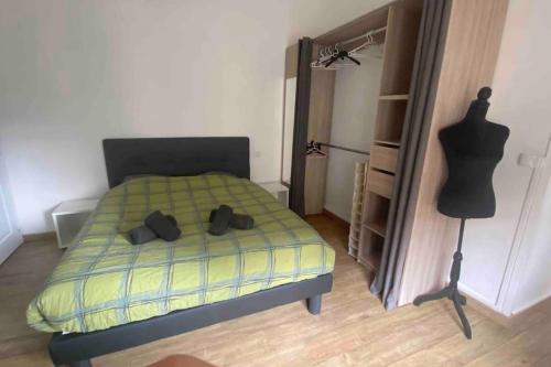 a bedroom with a bed with a dresser and a dummy at Appartement Dol de Bretagne centre in Dol-de-Bretagne