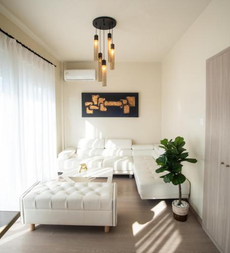 a living room with white furniture and a white couch at John's Hotel in Chalkida