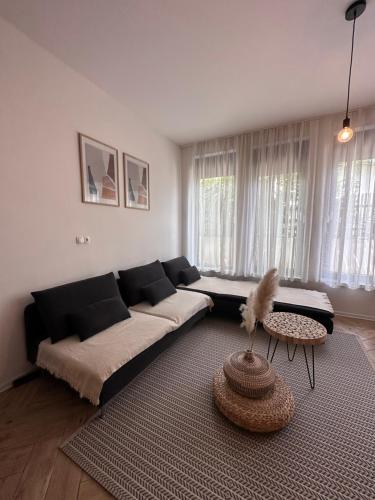 a living room with a couch and a table at Apartma Winter Garden Kranjska Gora in Kranjska Gora