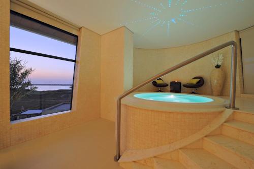 a wellness room with a tub and a large window at Radisson Blu Hotel, Abu Dhabi Yas Island in Abu Dhabi