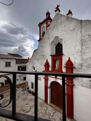 a building with a clock tower on top of it at Casa Veracruz in Benarrabá