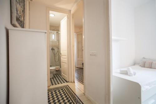 a room with a hallway with a bed and a bathroom at 42par1049 - Super Bright 3BR in Sant Antoni in Barcelona