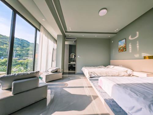 a bedroom with two beds and a large window at Yue Tong Farmer House in Huairou