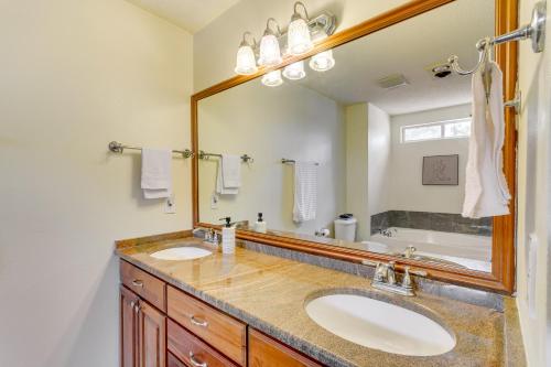 a bathroom with two sinks and a large mirror at Mary Esther Home with Private Pool and Fireplace! in Mary Esther