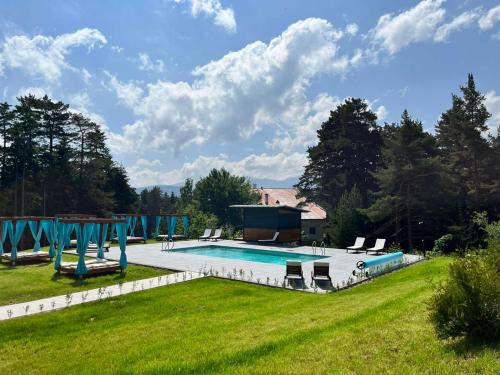 a swimming pool in a yard with a grass field at 103 View Park Hotel & SPA in Panichishte