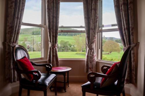 a room with two chairs and a large window at Ellerton Lodge Bed and Breakfast Swaledale in Richmond