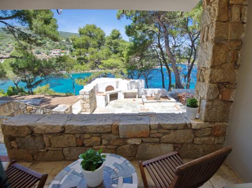 a patio with a view of the water and trees at Kavos Villa in Aghios Petros Alonissos