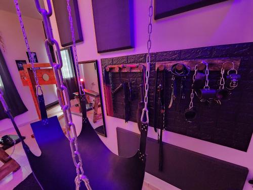 a room with a group of chains hanging from a wall at Taboo21+ in Ashkelon