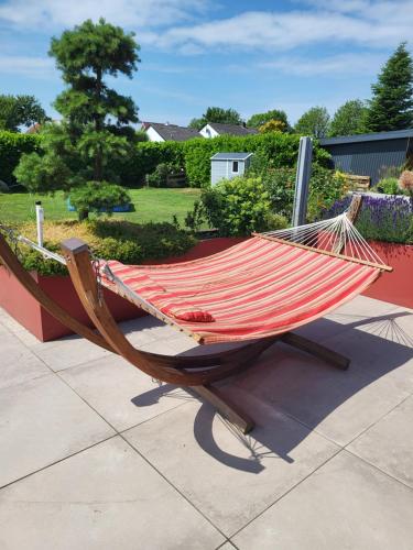 a hammock sitting on top of a patio at Das blaue Häusle in Hofe