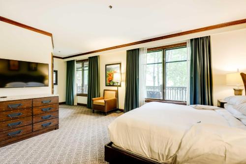 a bedroom with a large bed and a dresser and window at Ski Resort Condo in Ritz-Carlton Aspen Highlands in Aspen