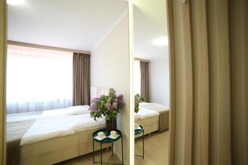 a hotel room with a bed and a mirror at Ośrodek Wypoczynkowy Pod Dębem in Wójtowice
