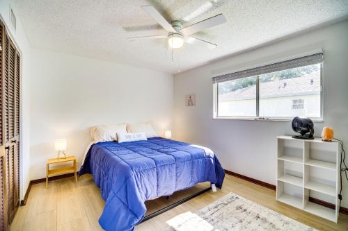 um quarto com uma cama azul e uma janela em Palm Bay Vacation Rental with Private Pool! em Palm Bay