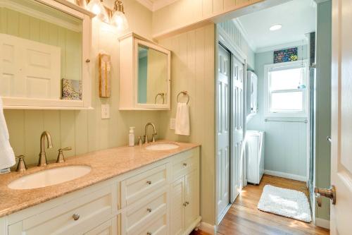 a bathroom with two sinks and a walk in shower at Jamaica Beach Home with Surrounding Water Views! in Galveston